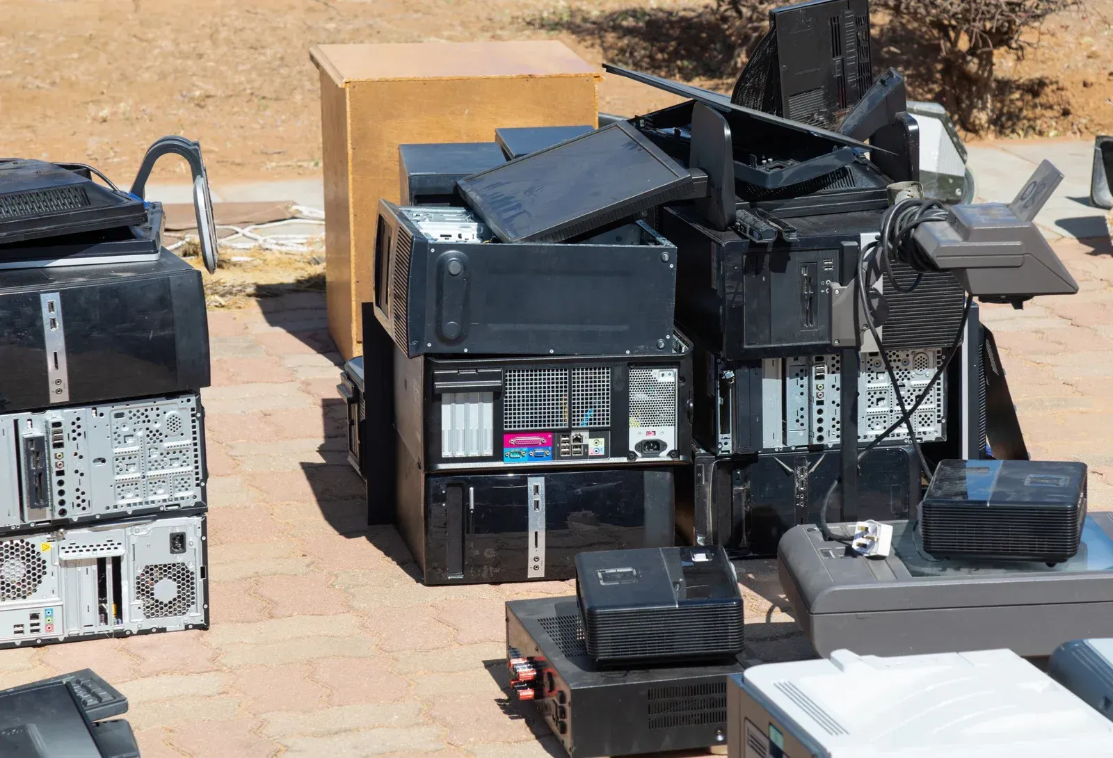 A bunch of old computers are stacked on top of each other