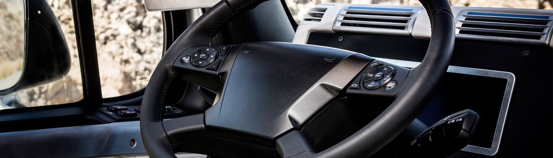 A close up of a steering wheel in a car