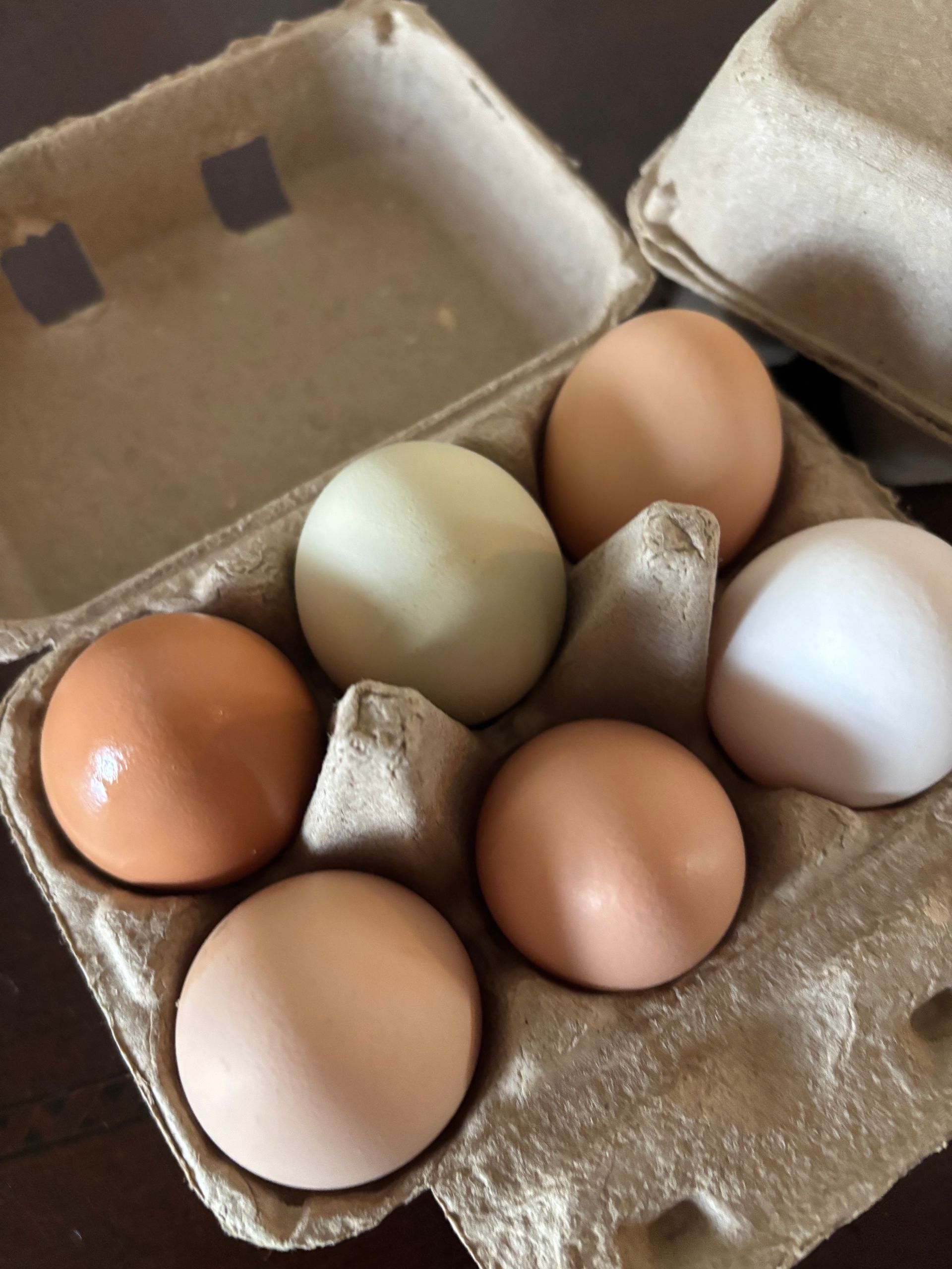 Jar of honey with wooden spoon, on a rustic wooden table.