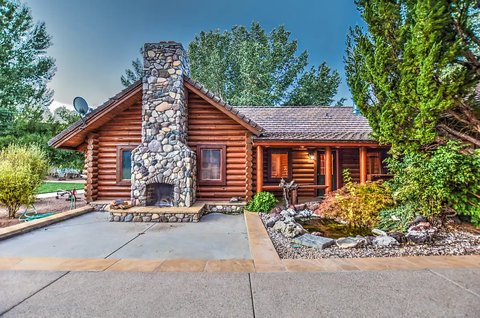 Wedding ceremony on a ranch, couple at altar, guests watch. Mountains in background.
