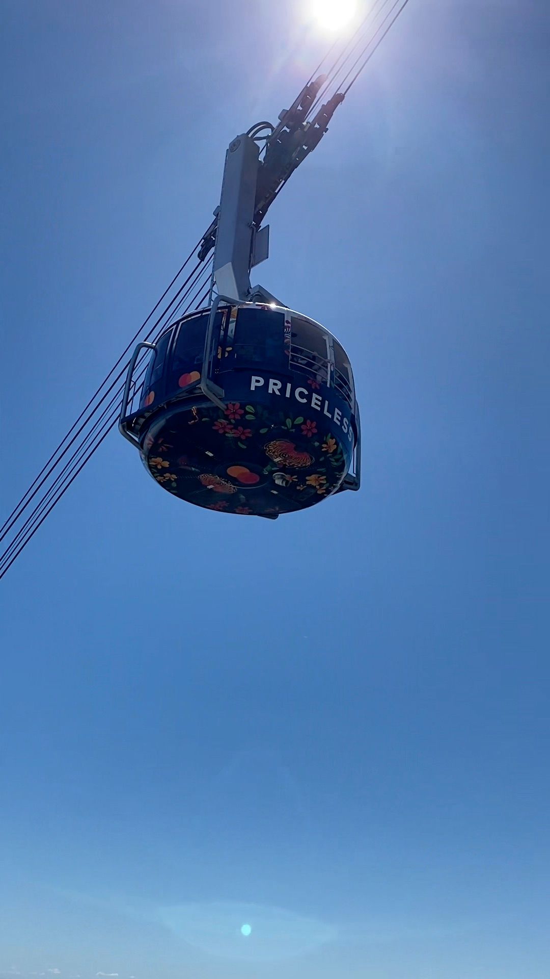 A cable car is flying through a clear blue sky in Cape Town Soith Africa