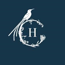 A bird with a long tail is sitting on a branch in a circle with the letter h.