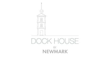 The logo for dock house by newmark has a tower on it.