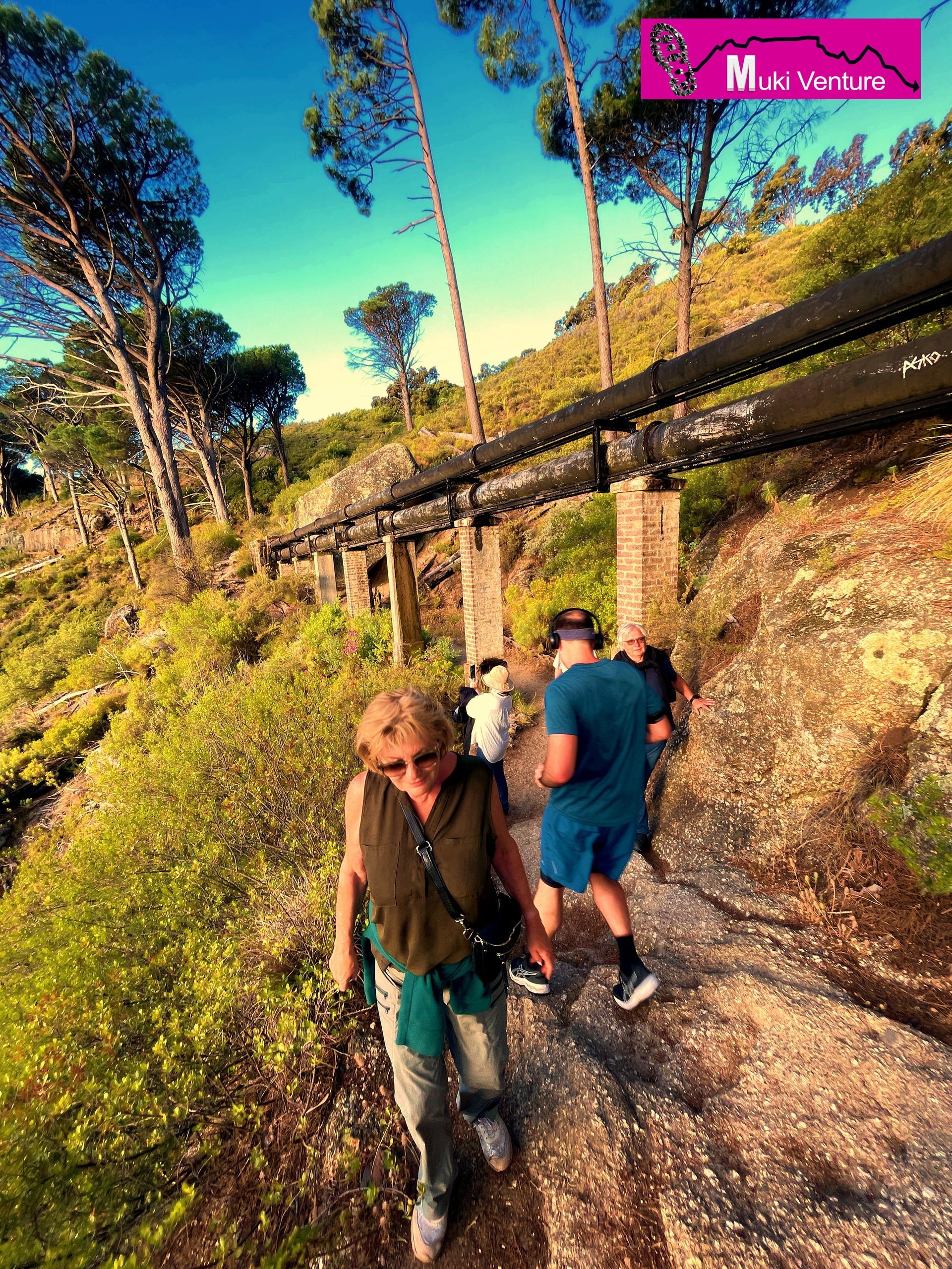 The Pipe Track Guided Tour is a thrilling adventure offered by Muki Venture that takes you on a scenic journey along Table Mountain in Cape Town. This tour is specifically designed to showcase the beauty of the mountain and the stunning views that surround it, especially during sunset.  As part of this tour, you will be accompanied by experienced guides who will lead you along the Pipe Track, a popular hiking trail that winds its way around the mountain. The track takes its name from the water pipe that runs alongside it, which used to supply water to the city of Cape Town.  Throughout the tour, you will have the opportunity to immerse yourself in the natural splendor of Table Mountain. The trail showcases breathtaking vistas of the Atlantic Ocean, the Twelve Apostles mountain range, and the vibrant cityscape below. You will witness the changing colors of the sky as the sun sets, creating a magical ambiance.  Muki Venture ensures that this guided tour is suitable for participants of all fitness levels, allowing everyone to appreciate the beauty of Table Mountain at their own pace. Along the way, the guides will share interesting facts and stories about the mountain's history, flora, and fauna, adding depth to your experience.  Don't miss out on this unforgettable adventure that combines the thrill of outdoor exploration with the mesmerizing beauty of Table Mountain. Join the Pipe Track Guided Tour with Muki Venture and create lasting memories of a sunset experience like no other.