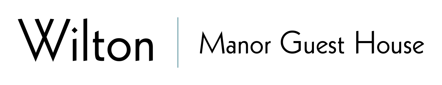 A black and white logo for wilton manor guest house