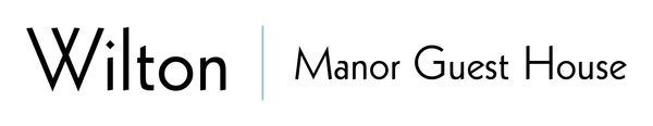 A black and white logo for wilton manor guest house
