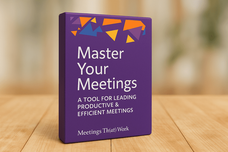 Book cover titled "Master Your Meetings," on a wooden surface.