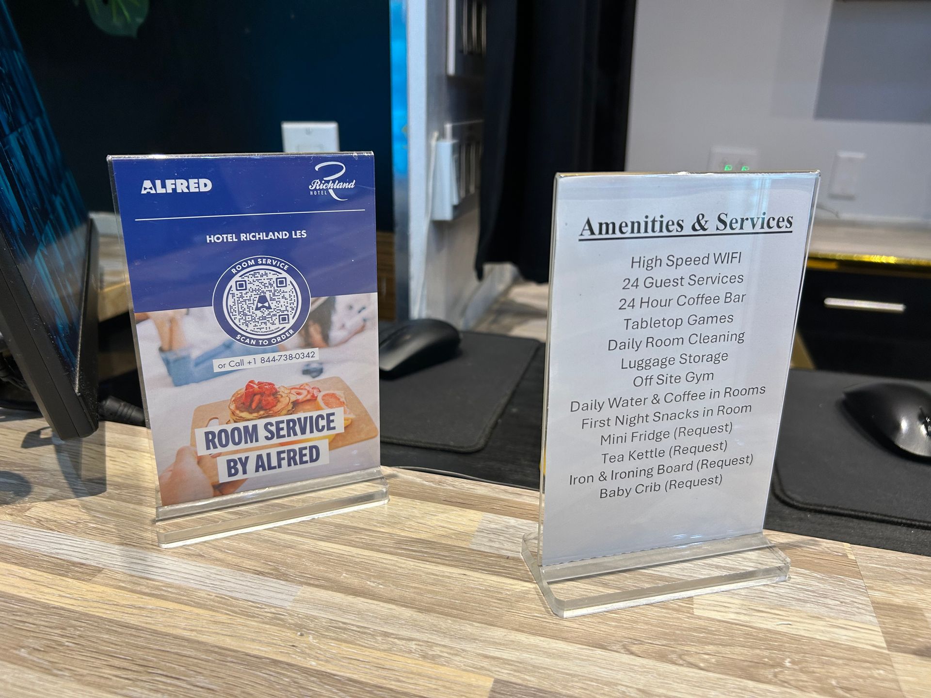 Two signs on a counter: one advertising 