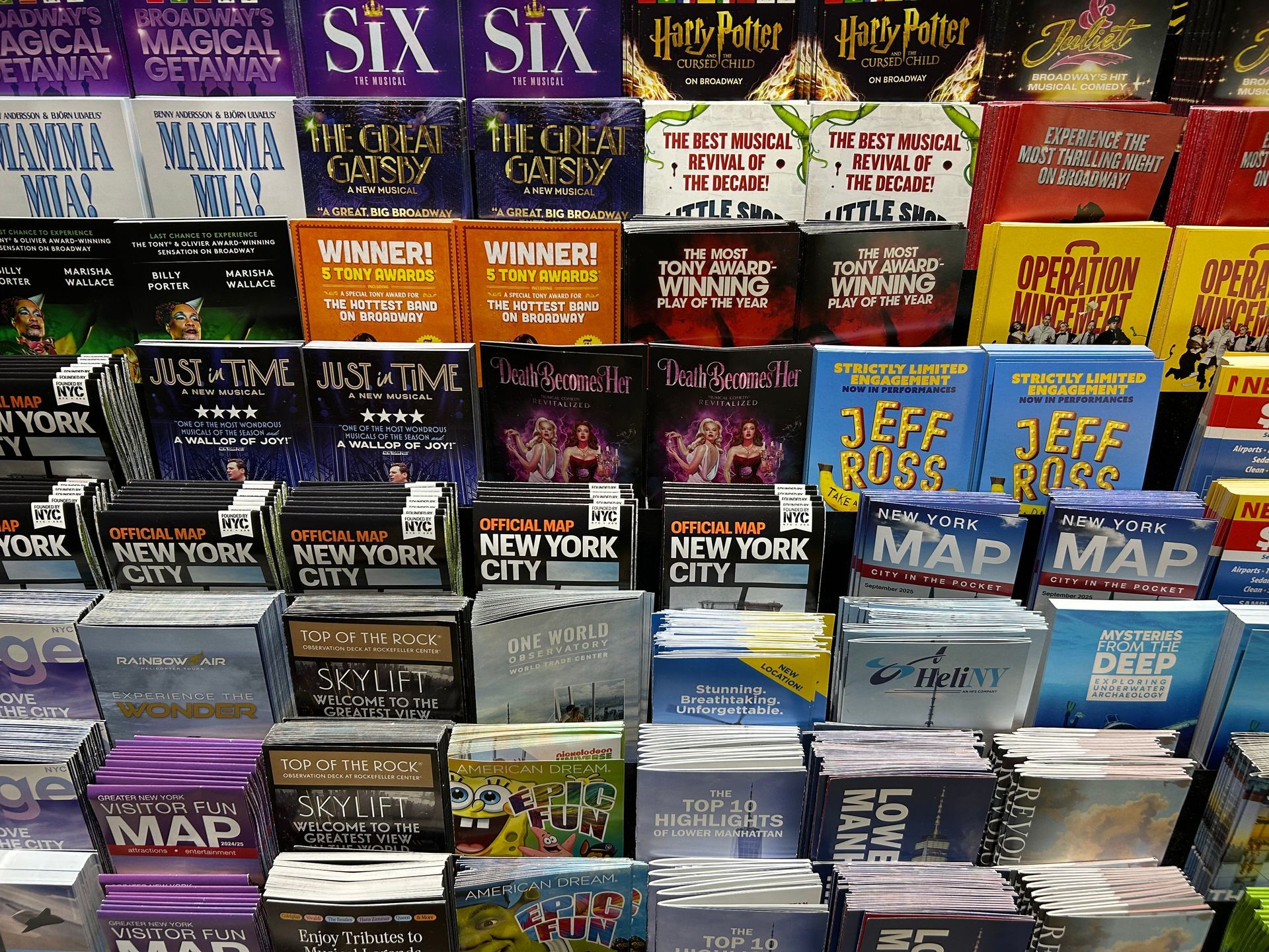 Shelf display of theater show souvenirs.