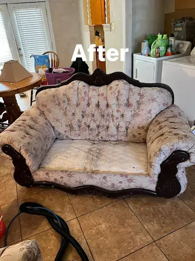 Vintage floral patterned sofa with dark wood trim; 