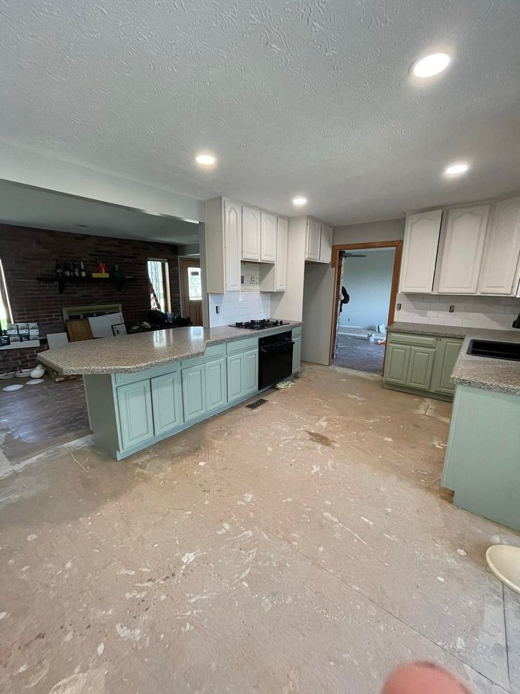 A kitchen with white cabinets and granite counter tops is being remodeled.