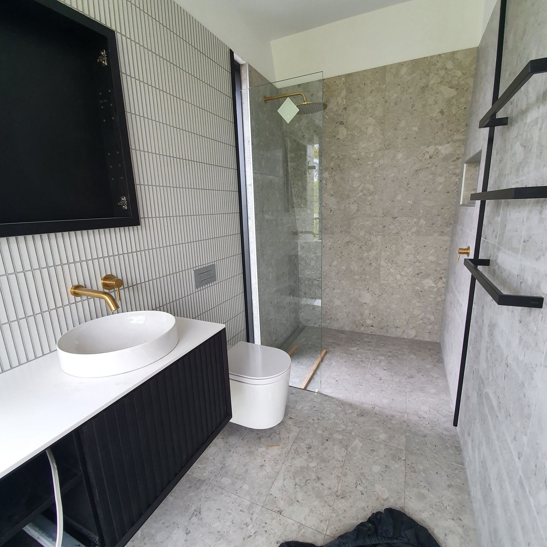 A bathroom with a sink and a walk in shower