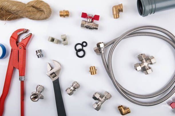 A bunch of plumbing tools on a white surface