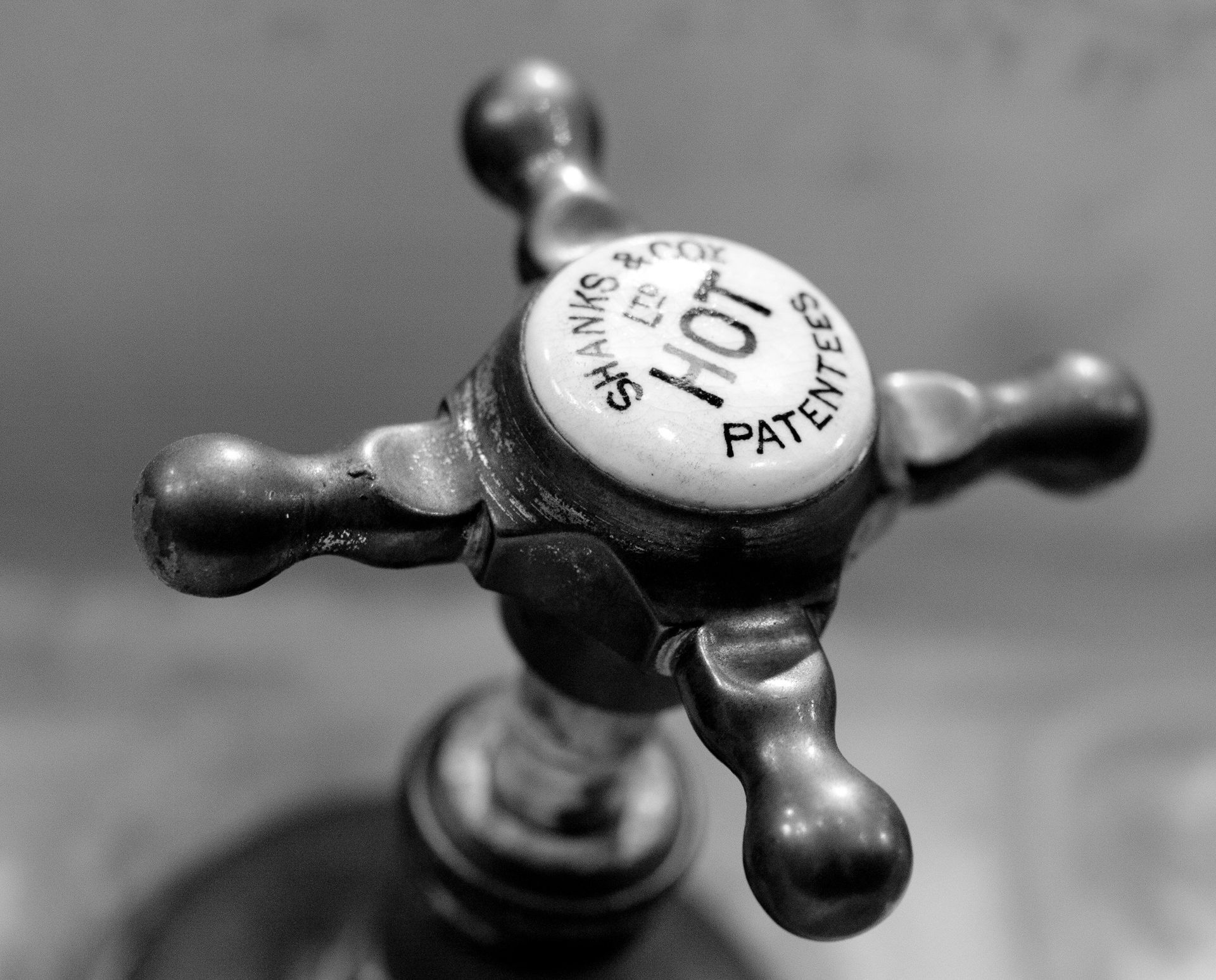 A black and white photo of a hot water faucet