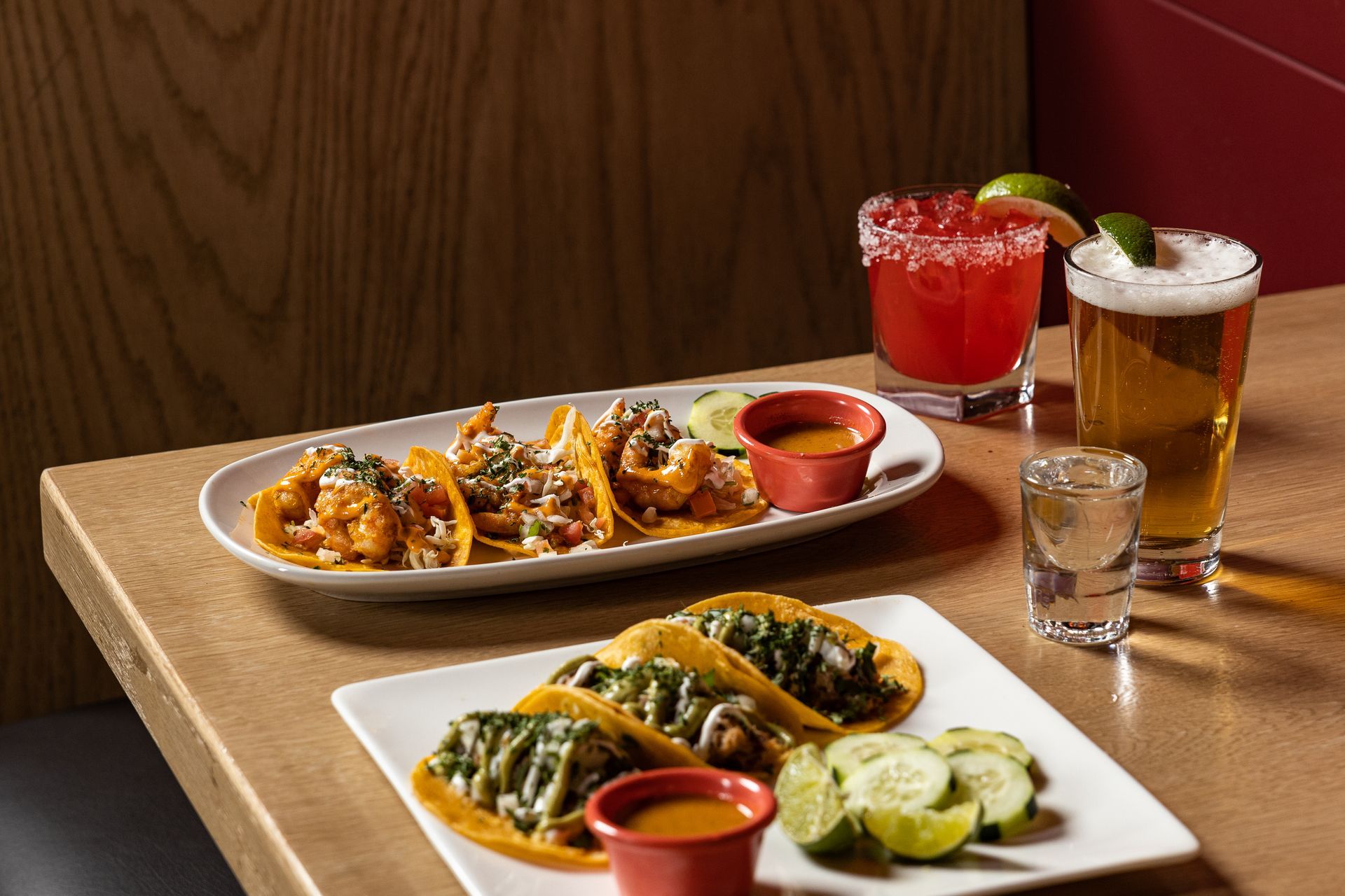 A table topped with plates of food and drinks at con safos in downtown denver near coors field