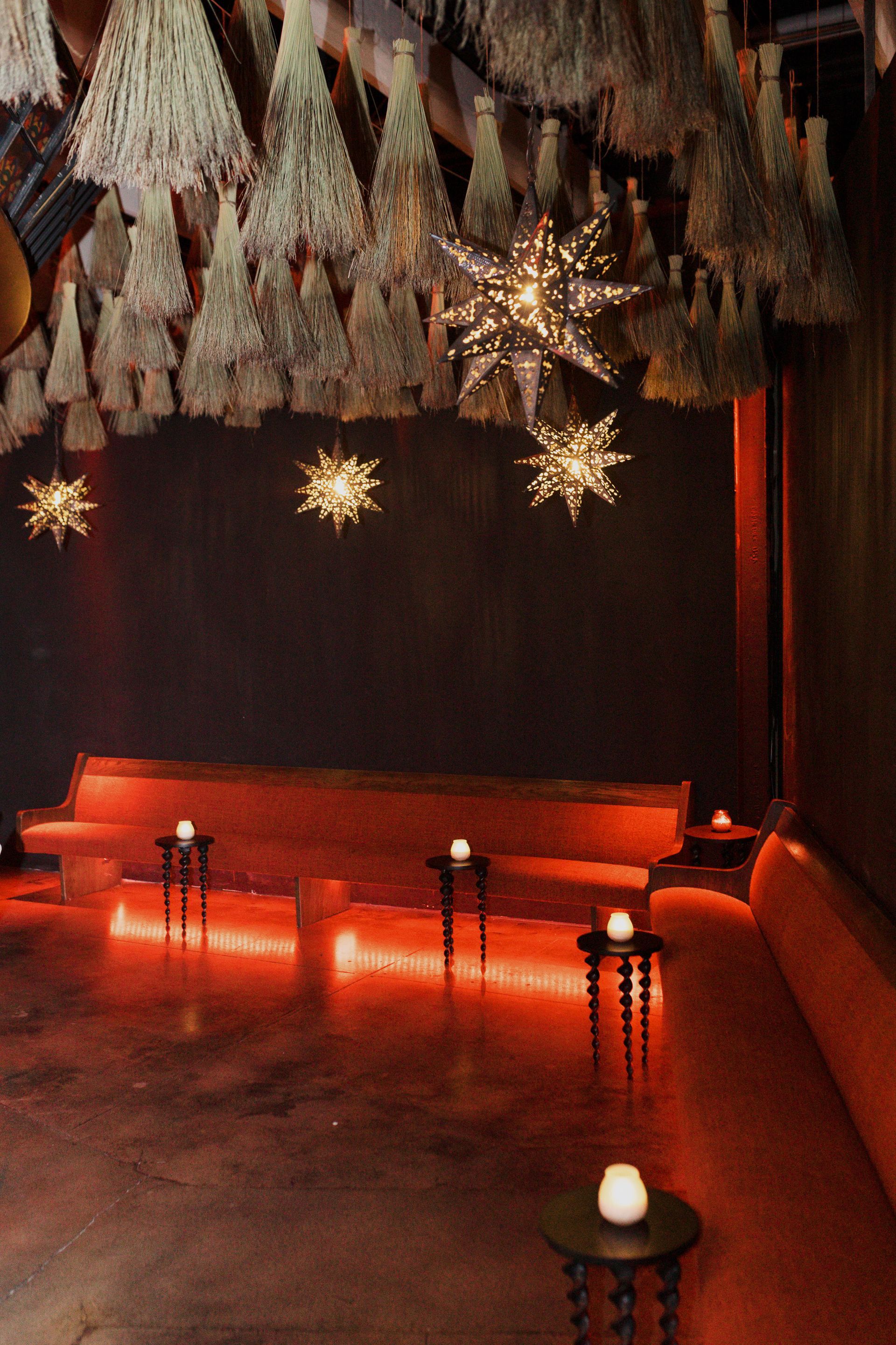 A room with a lot of lights and candles at agua bendita, a speakeasy in downtown denver colorado