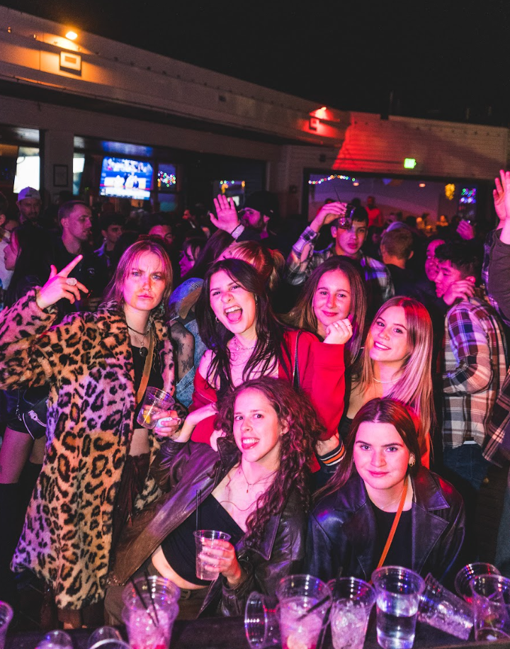 A group of people are posing for a picture at El Patio in denver colorado near coors field