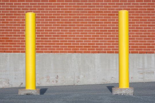 2 yellow bollards installed