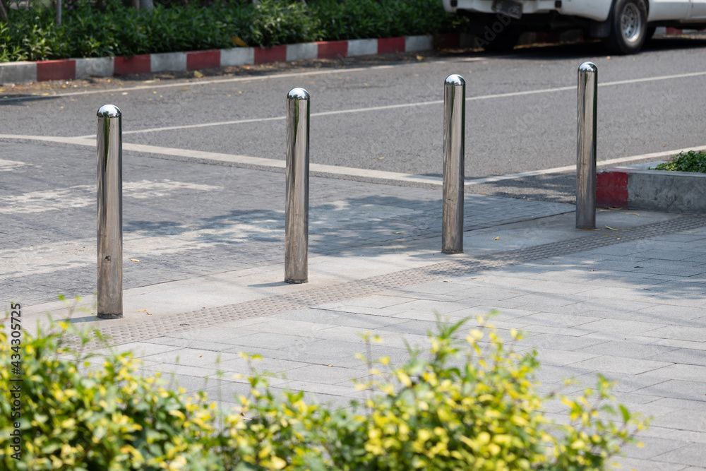 chrome bollard installed near walkway