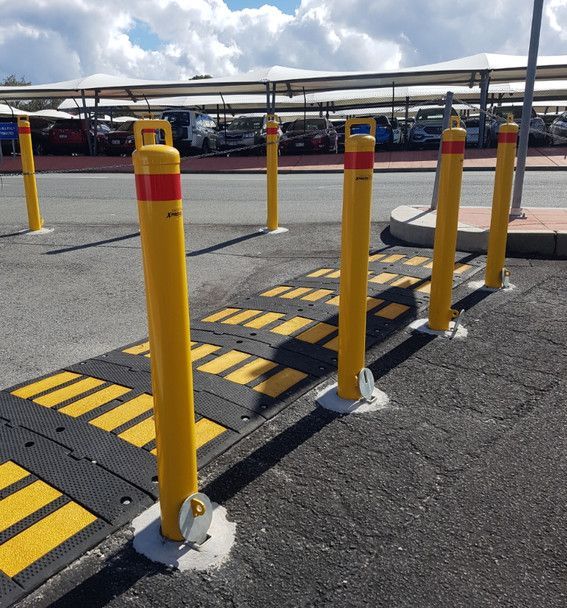 yellow bollard at a speed hump to prevent vehicle access