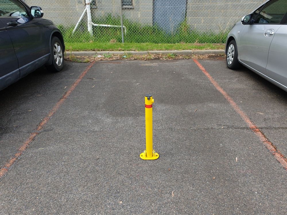 Parking fold down bollard installed to safeguard a parking spot 