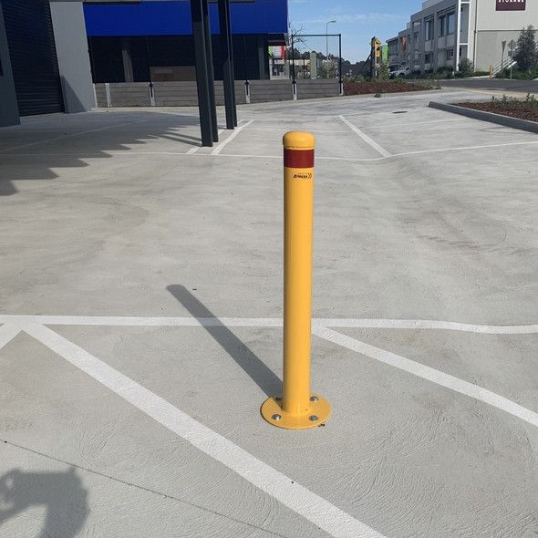 yellow bollard installed in a no parking zone