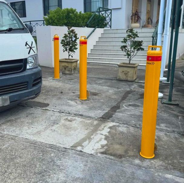 Bollards installed in front of stairs and a van