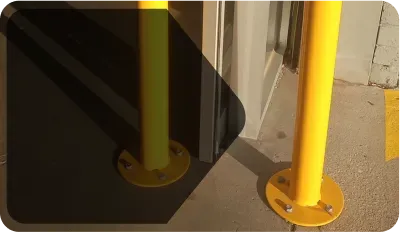 bass of a yellow surface mount bollard