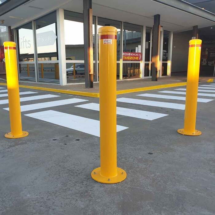 3 bollards protecting walkway from vehicles