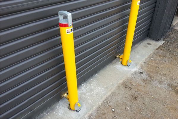 bollards hooked on to a roller door to prevent ram raids