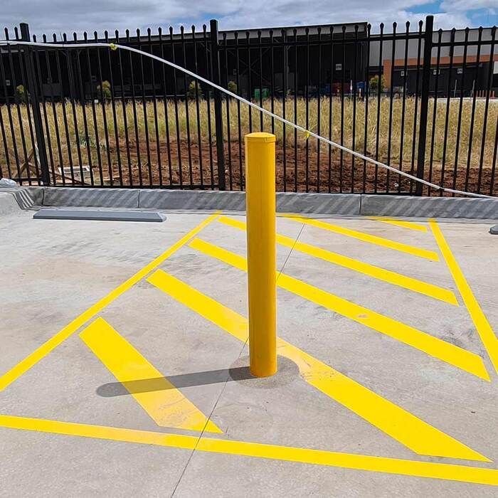 yellow bollard in no parking zone