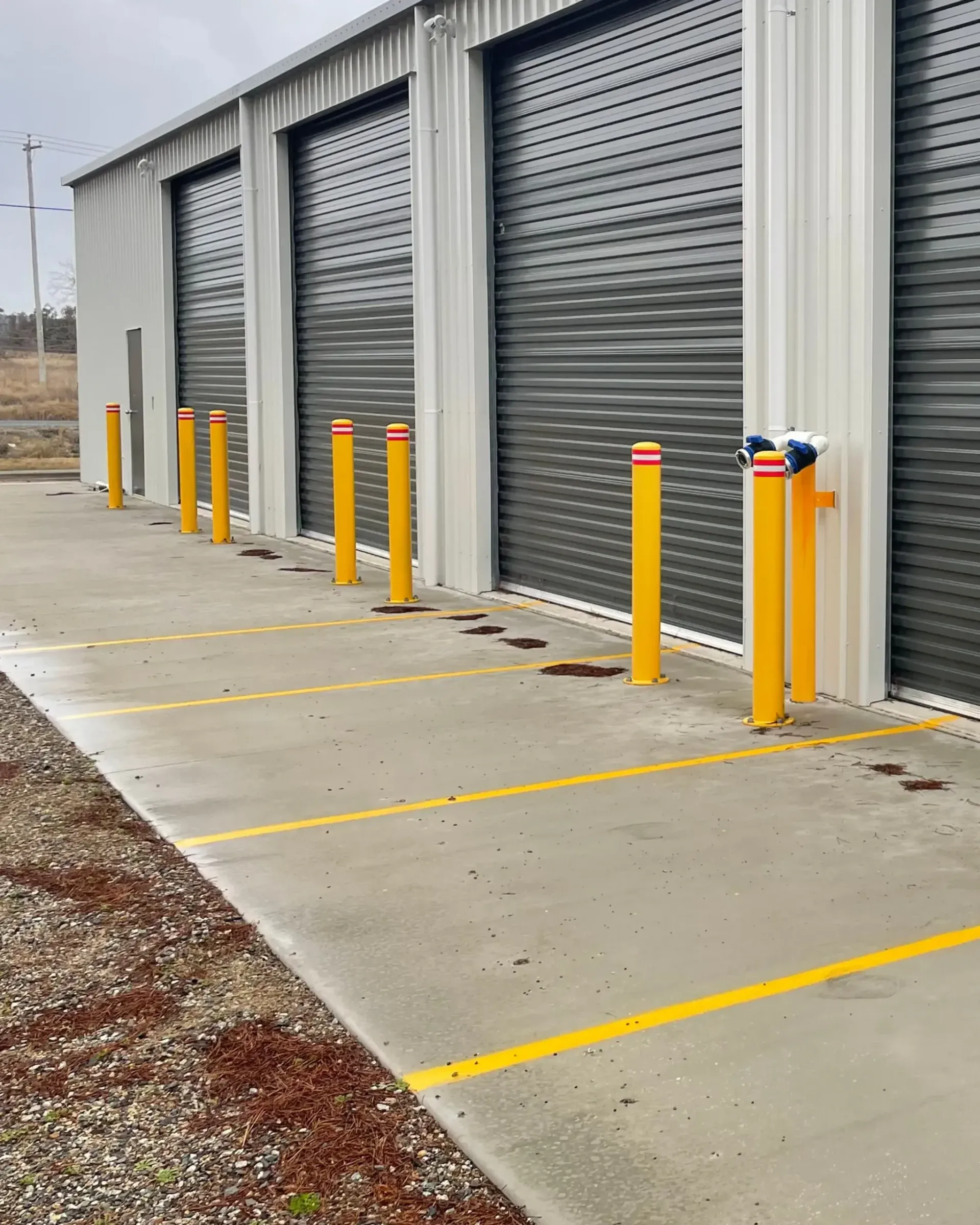 a group of bollards in the front of a workshop