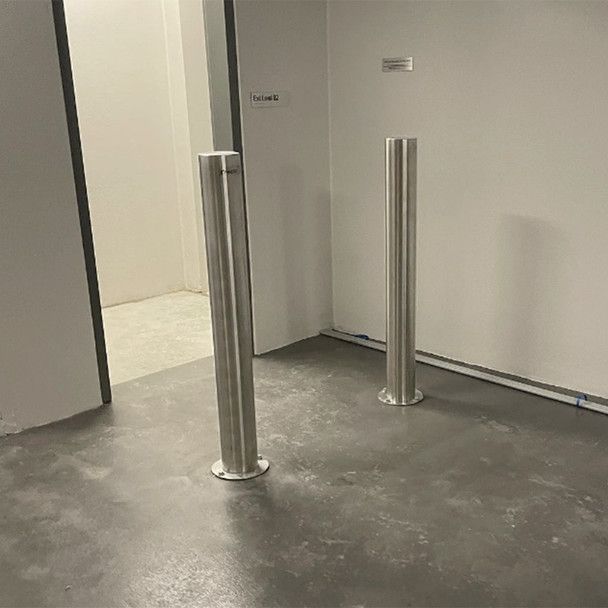 2 chrome bollards blocking walkway