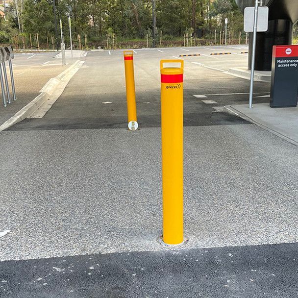 2 yellow in ground removable bollards installed to prevent vehicle access
