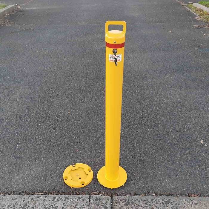 yellow removable bollard with a key inserted
