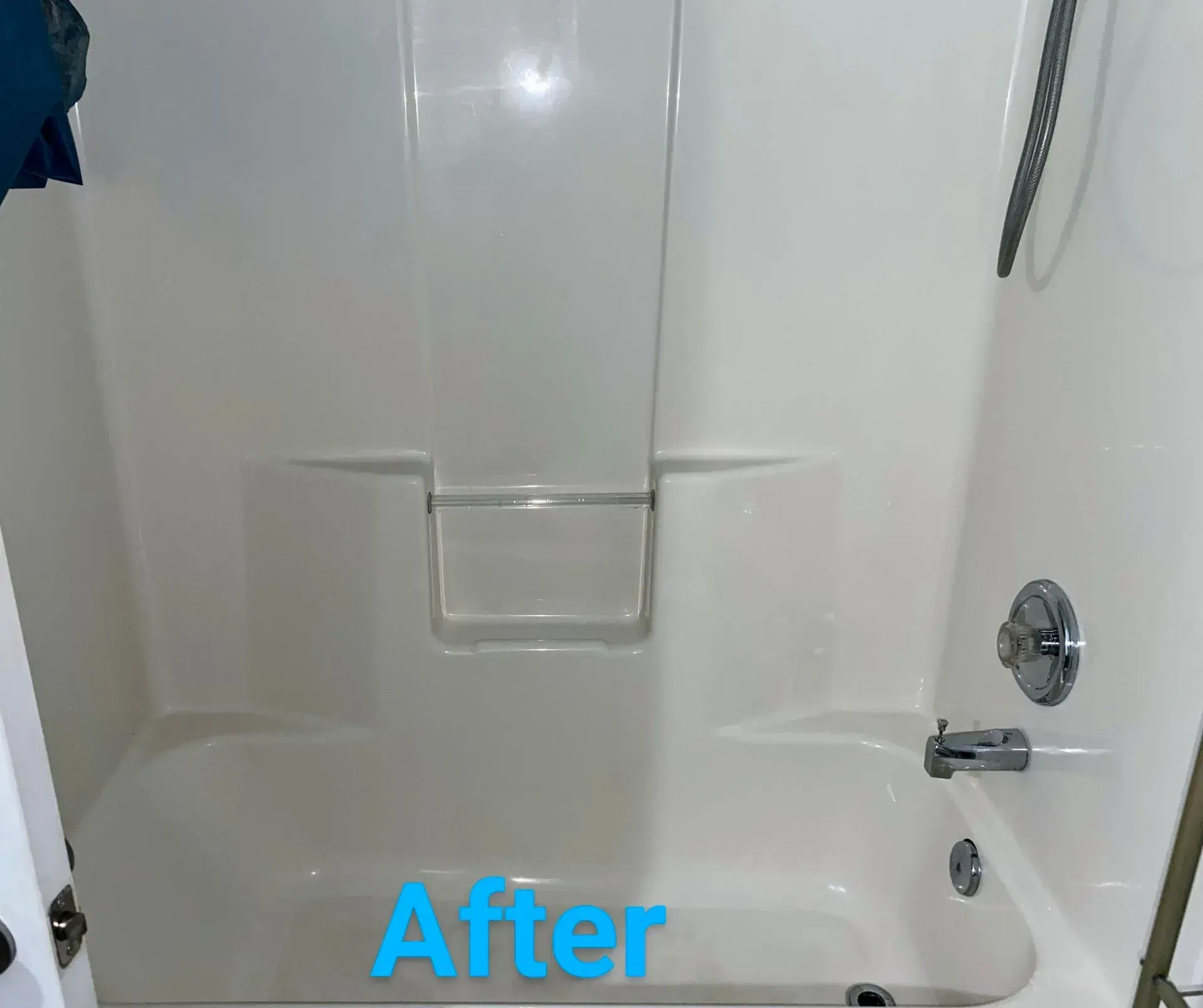 Clean, white bathtub and shower surround, with faucet and showerhead, viewed indoors.