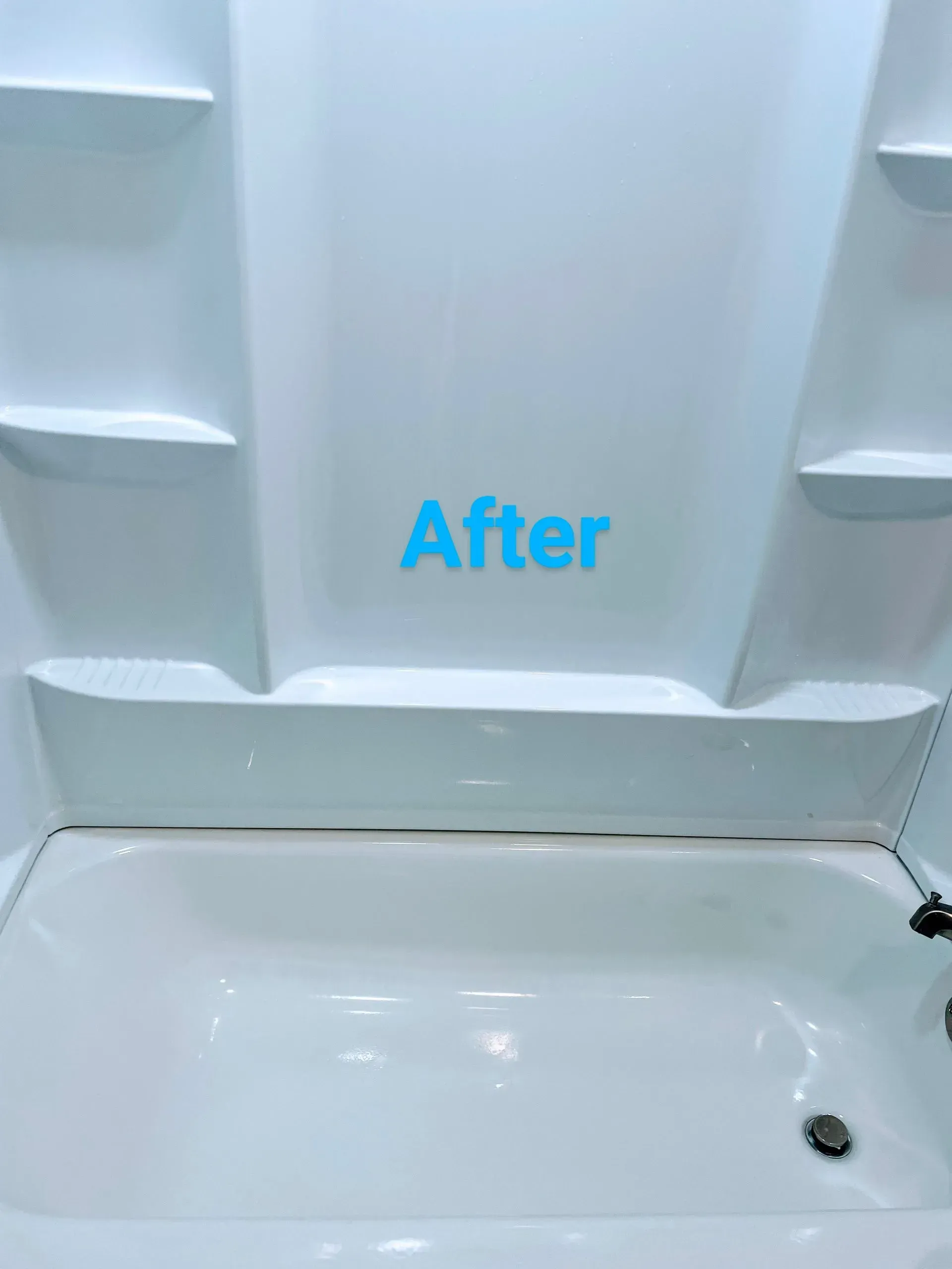Clean white bathtub and shower surround, 