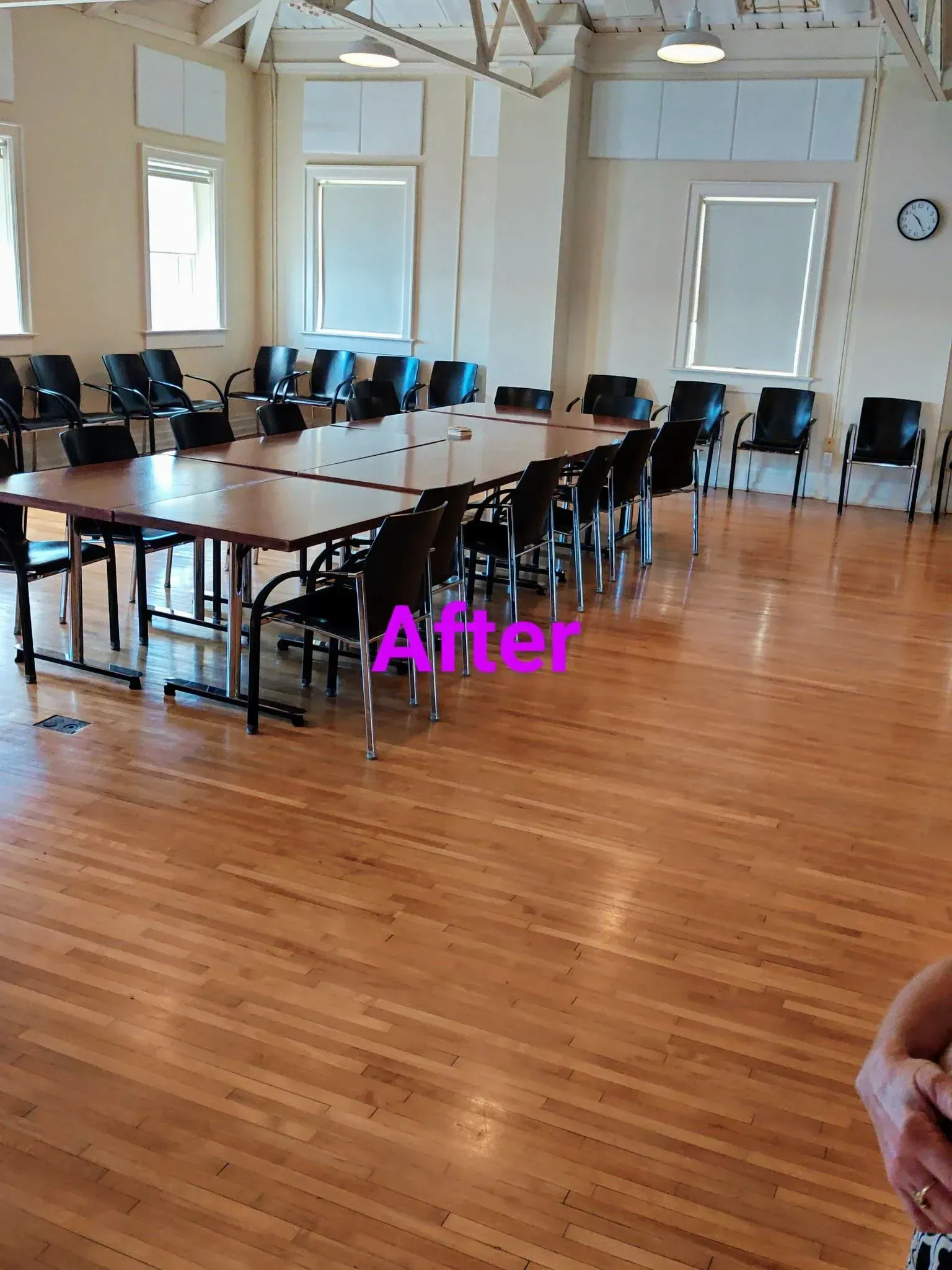 A conference room with a long table and chairs set up for a meeting. 