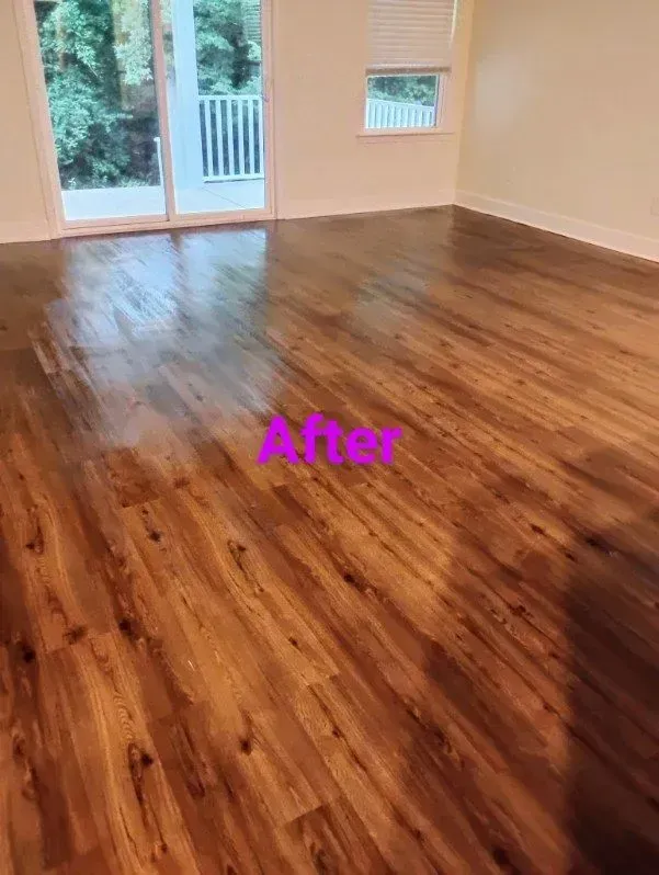 Newly polished wooden floor in a room with a balcony and window.
