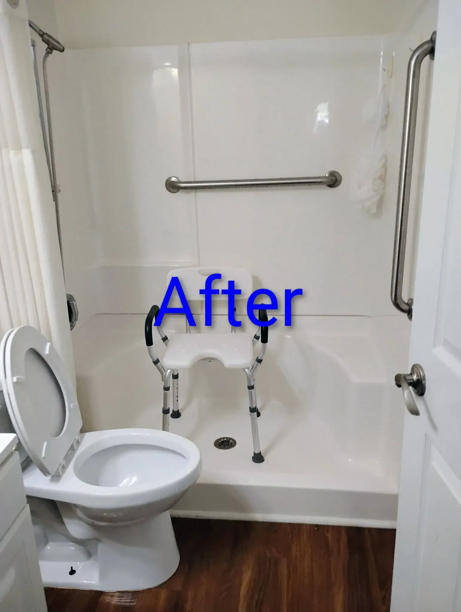 Accessible bathroom with shower, toilet, grab bars, and shower chair.  Dark wood floor, white walls. 