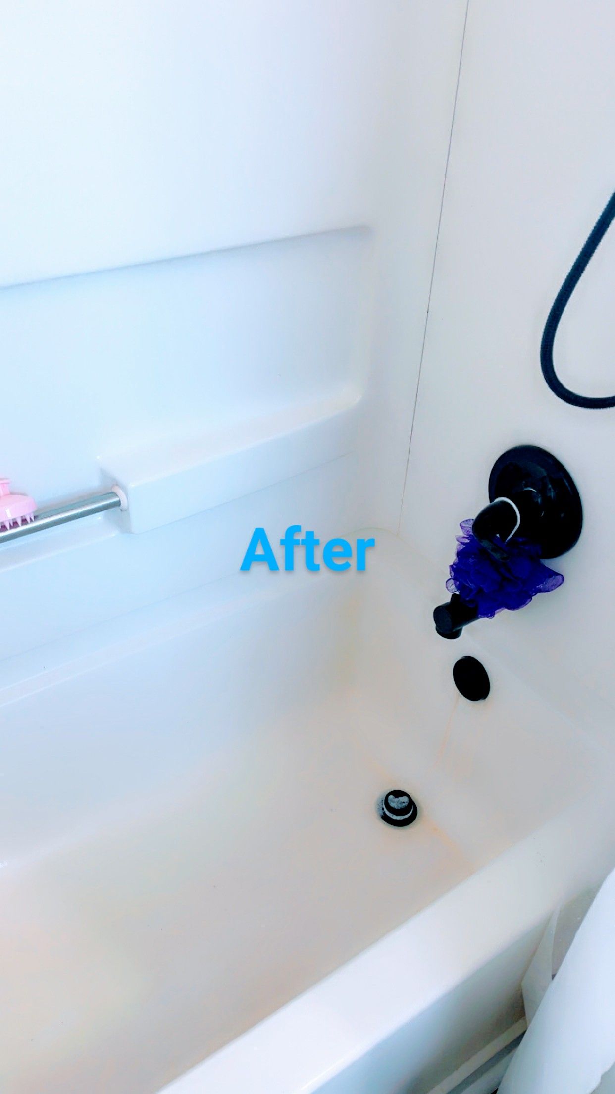 White bathtub with black faucet fixtures; the word 
