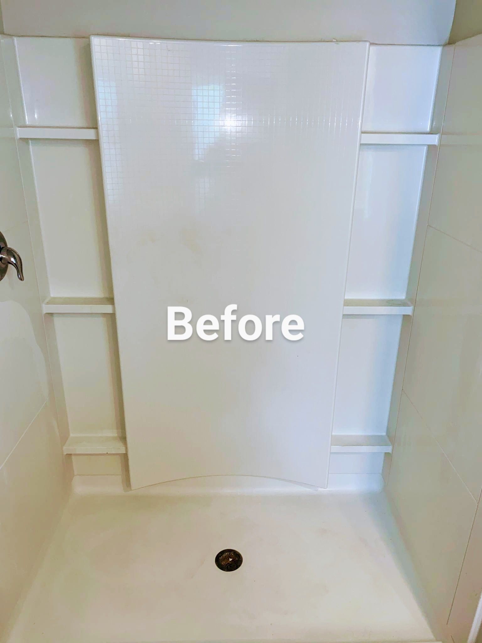 White shower stall with center panel, shelves, and drain. Text overlay: 