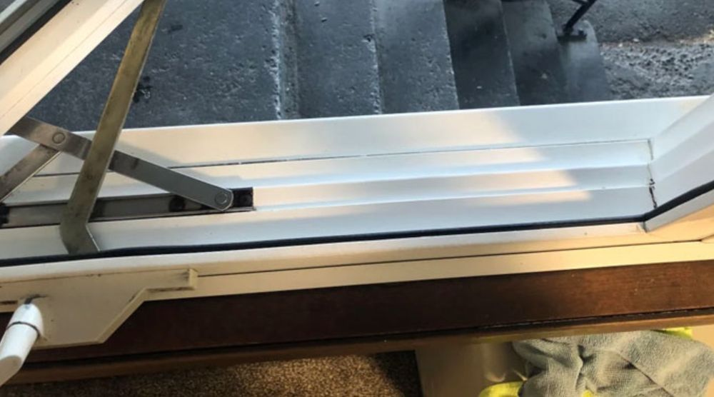 A close up of a window with a broken handle.