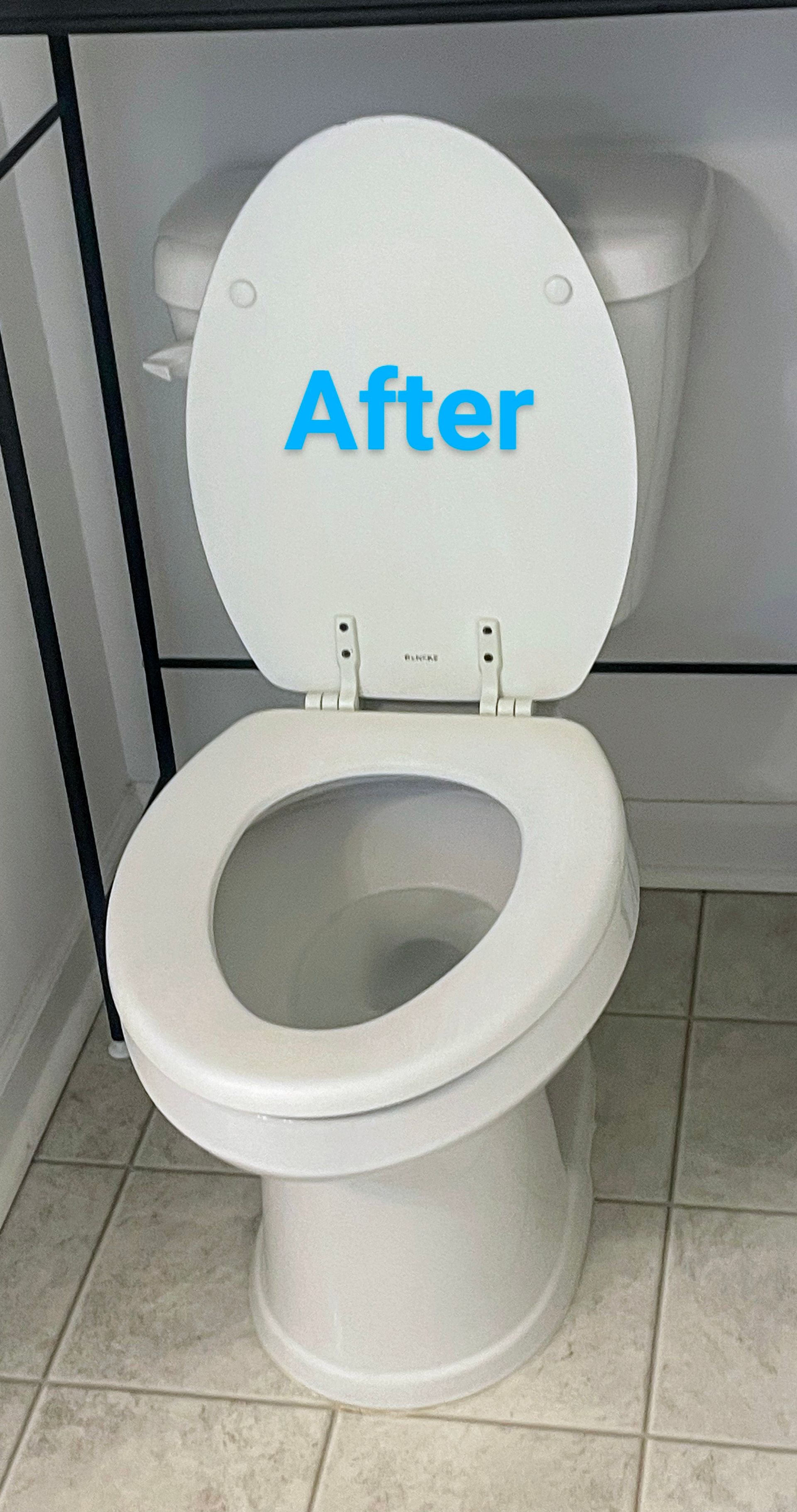 White toilet with the lid up and the word 