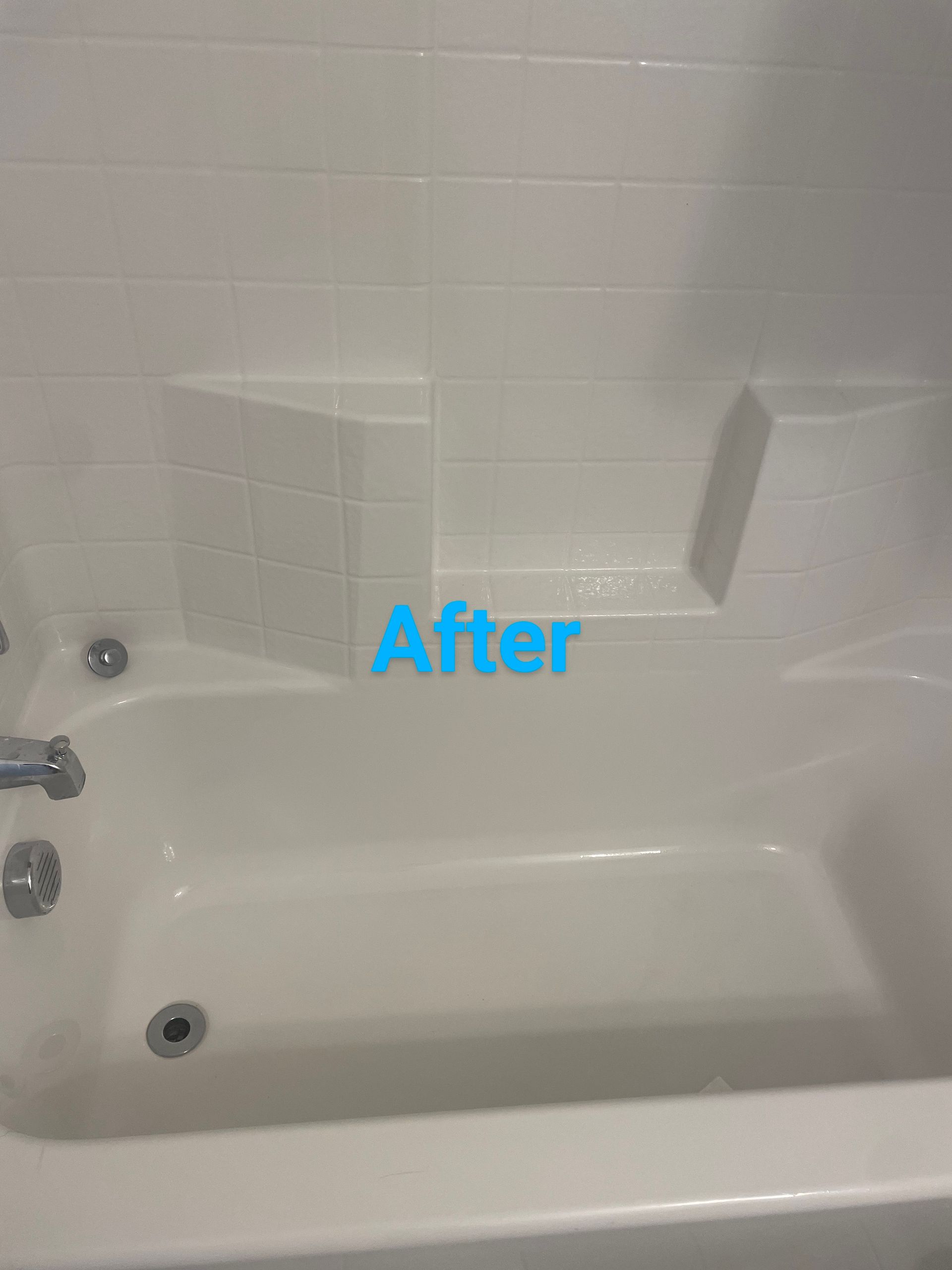 White bathroom tub with tile surround, after remodel.