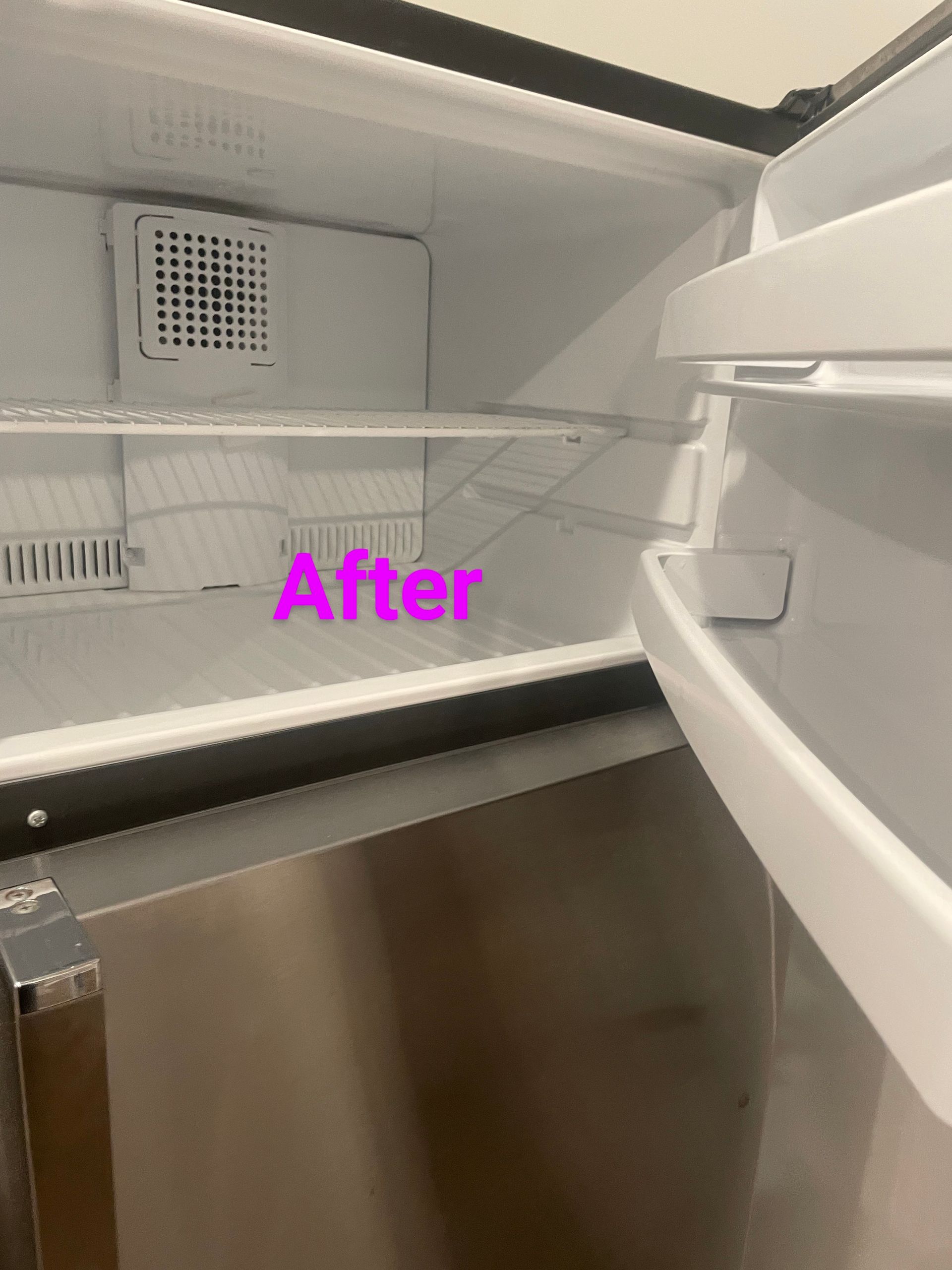Inside of a clean, empty refrigerator with a stainless steel exterior; door open. 