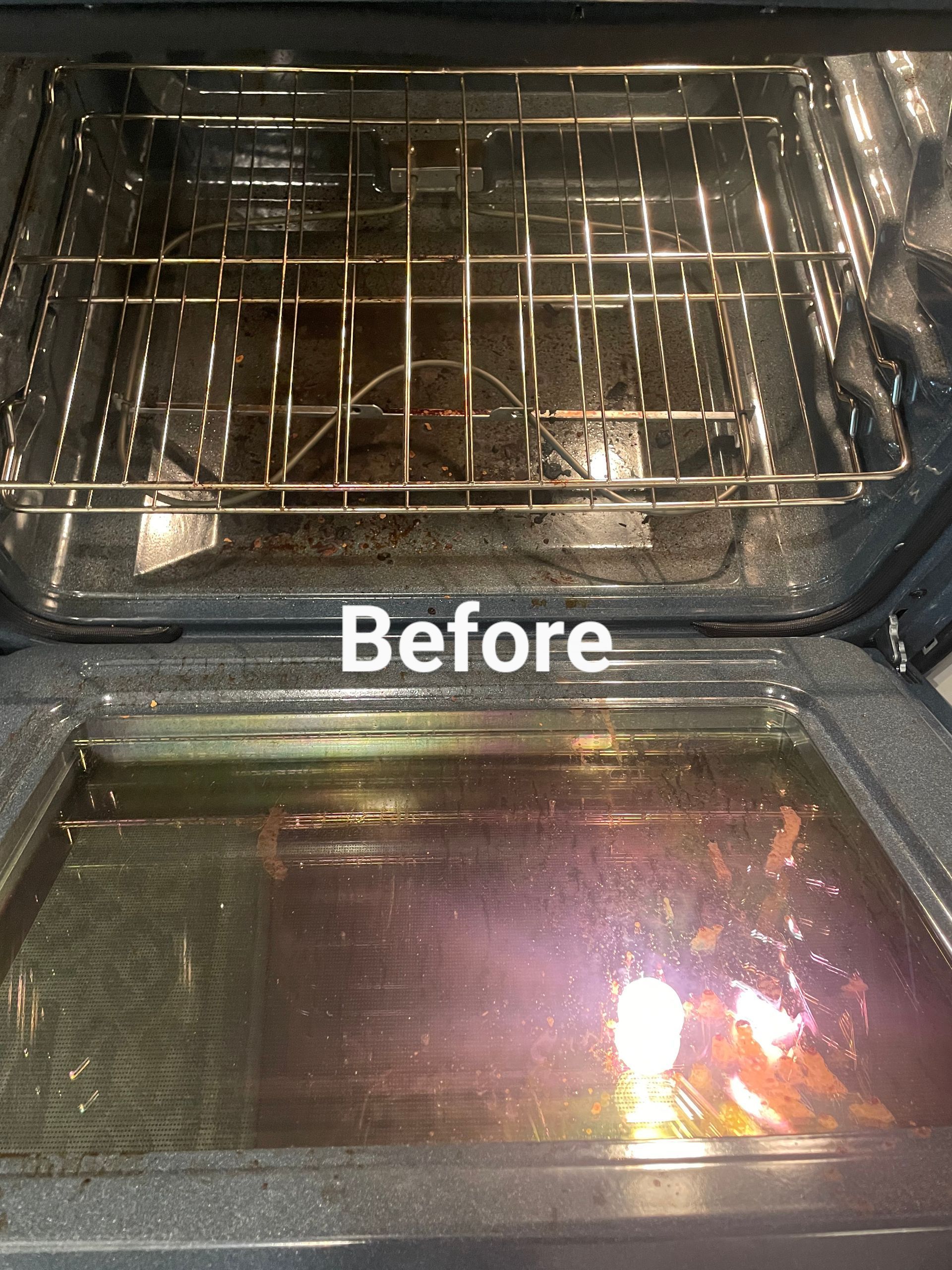 Dirty oven interior, top rack and bottom pan visible, with food debris and grease.