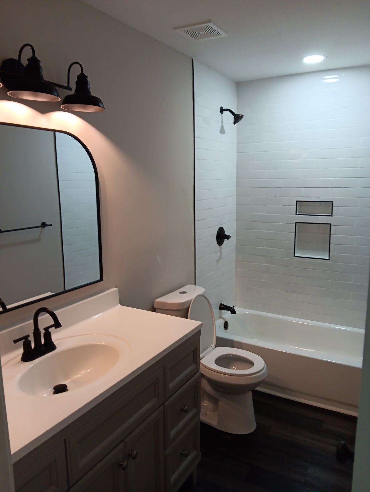 A bathroom with a sink toilet and bathtub
