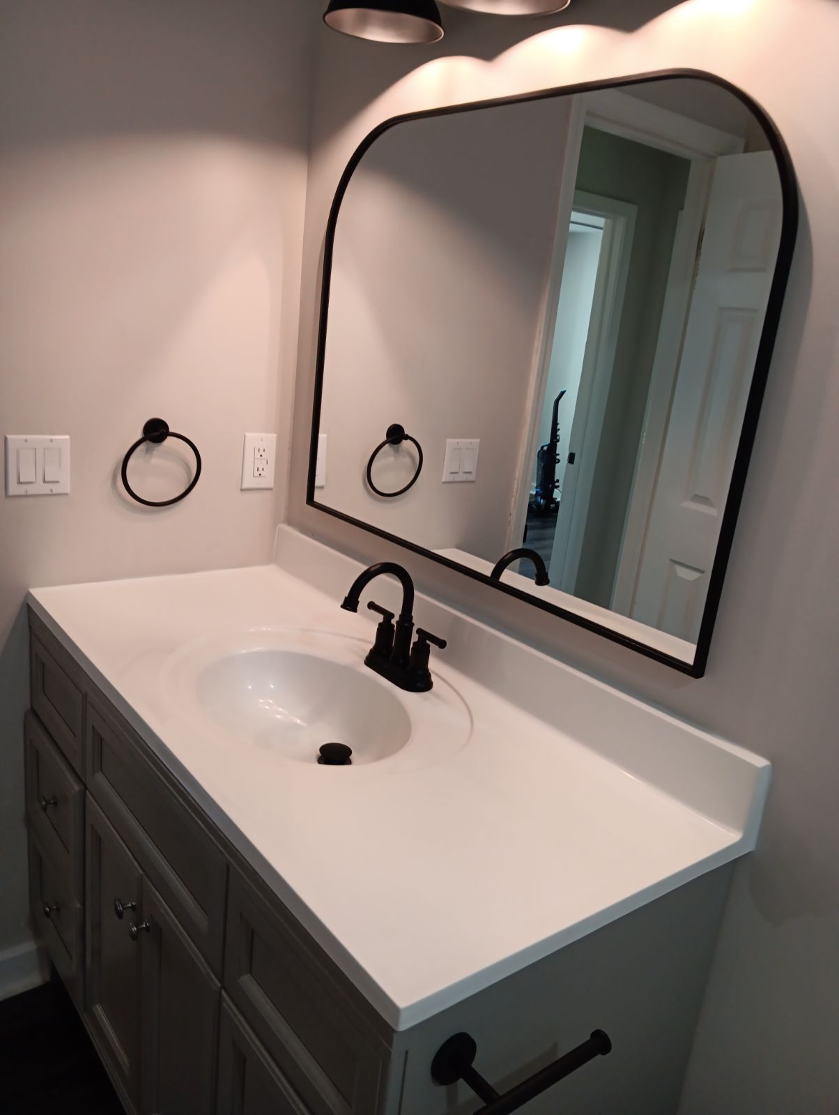 A bathroom sink with a large mirror above it.