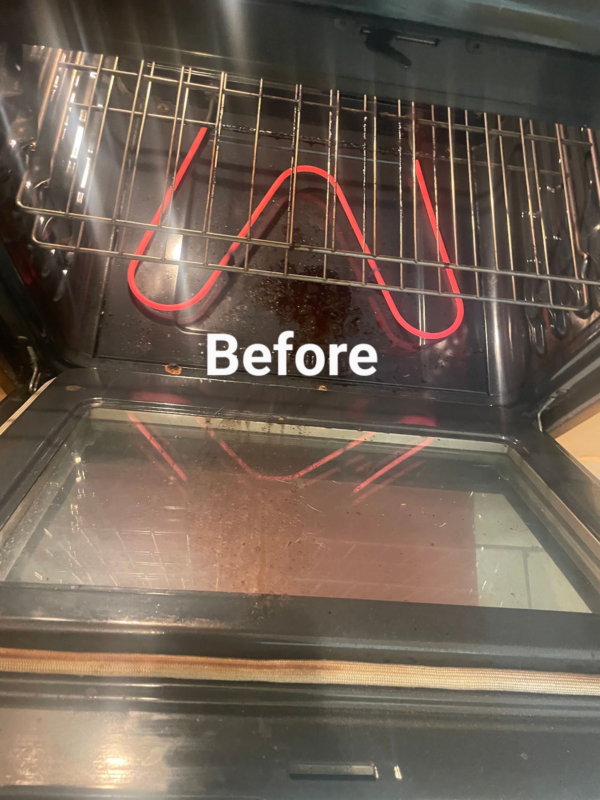 Oven interior with a red heating element, racks, and a dirty glass door, labeled 
